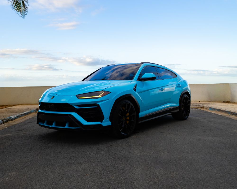 Blue Lamborghini Urus driving Puerto Rico scenic road